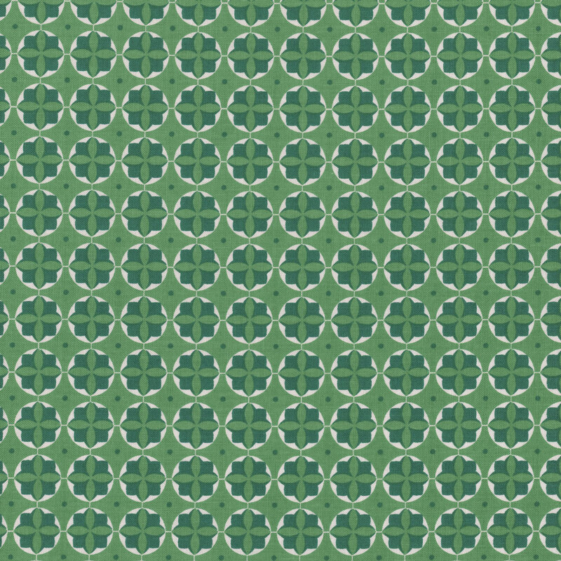 Green geometric fabric featuring a floral medallion design