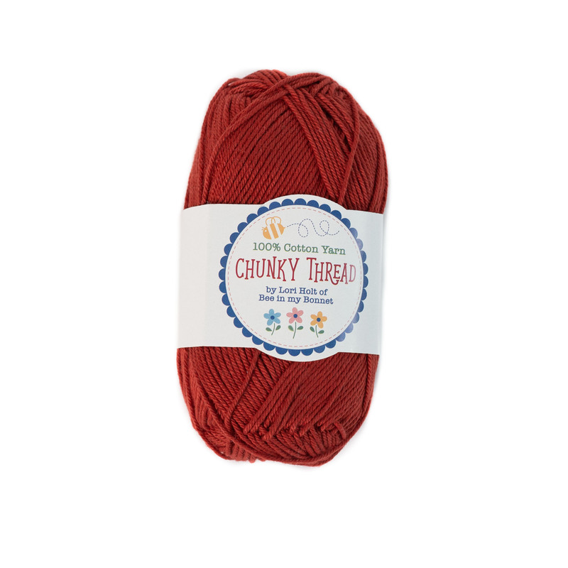 A skein of the Schoolhouse Red Chunky Thread, isolated on a white background.
