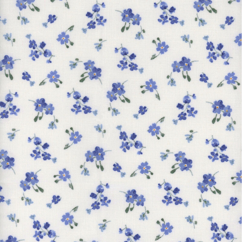 White fabric with tossed blue floral bouquets in a ditsy pattern