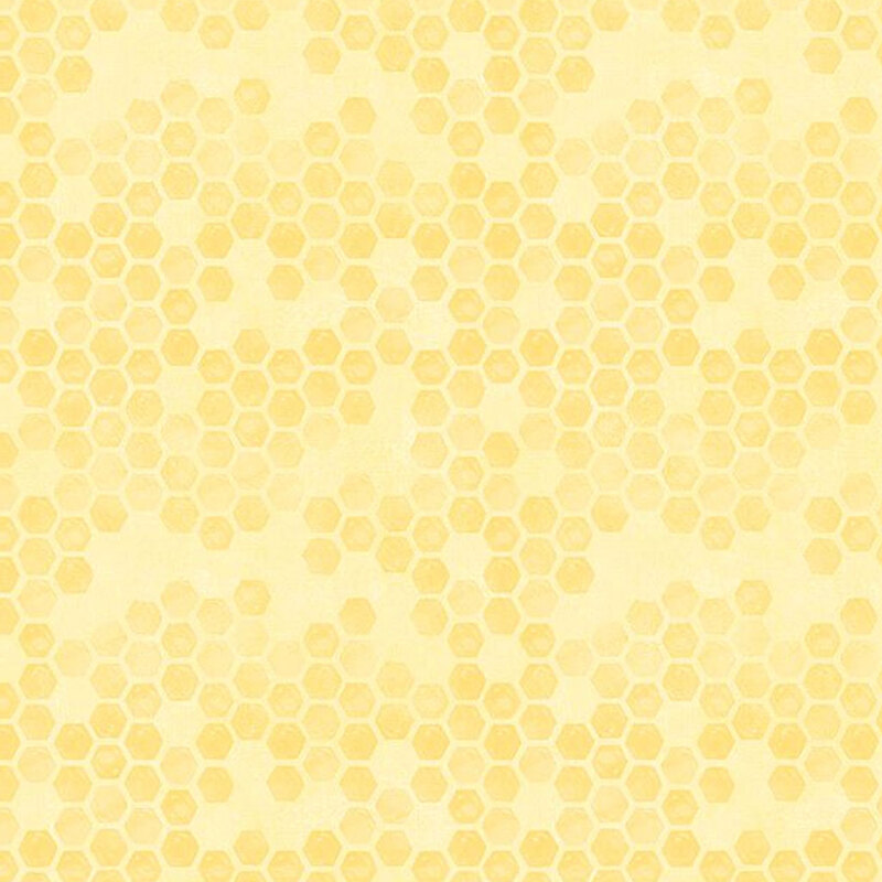 Pastel yellow tonal fabric with a scattered beehive pattern throughout