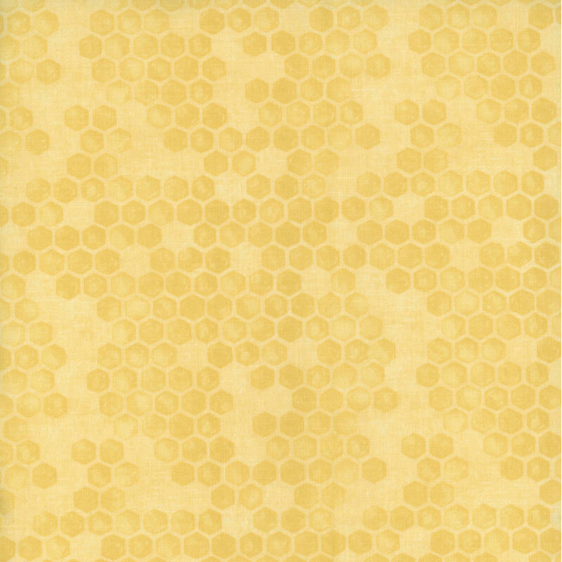 Pastel yellow tonal fabric with a scattered beehive pattern throughout