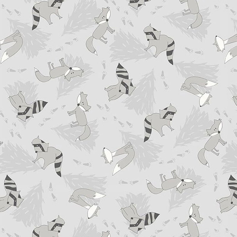 Gray fabric with darker gray pine trees in the background and illustrated racoons and wolves tossed throughout