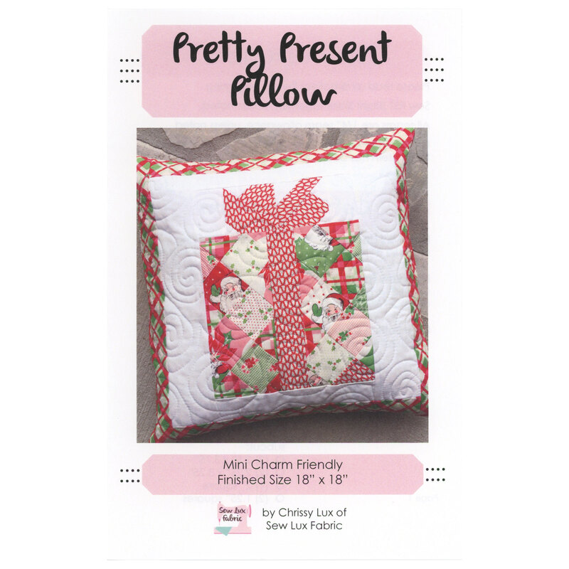 Front cover of the Pretty Present Pillow pattern showing the finished pillow isolated on a stone background.