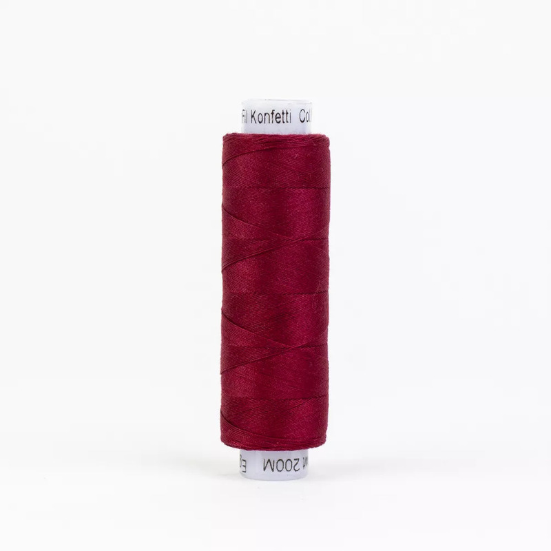 Spool of KT301 Burgundy thread, isolated on a white background
