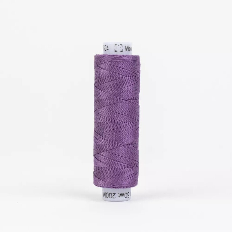 Spool of KT604 Mauve thread, isolated on a white background