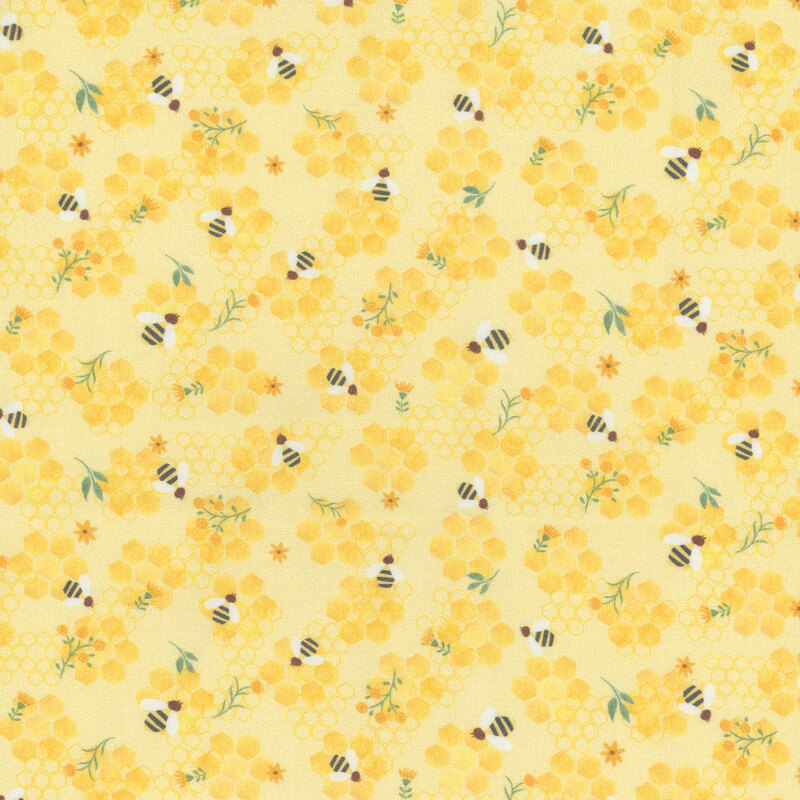 Yellow fabric scattered with bees, florals, and honeycombs