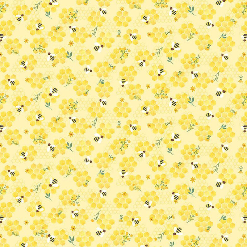 Yellow fabric scattered with bees, florals, and honeycombs