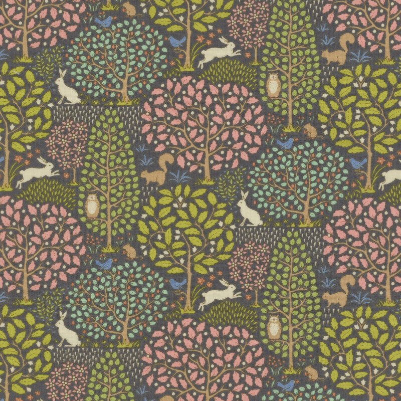 Dark gray fabric with large green and pink leafy trees and rabbits, squirrels, birds, and owls scattered across the scenery.