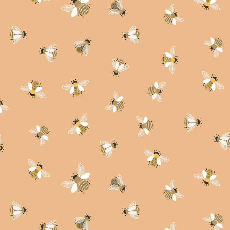 Peach fabric with scattered bees flying and in place from a top-down view.