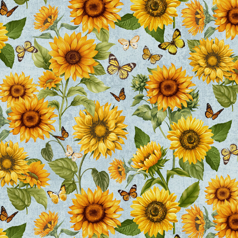 Sky blue fabric with large yellow sunflowers, green leaves, and scattered butterflies throughout