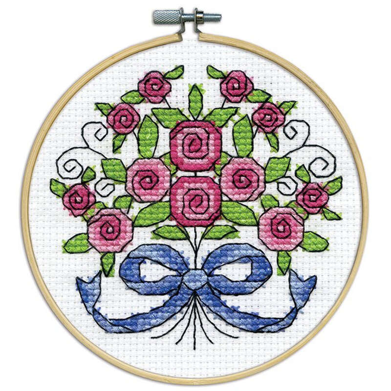 A closeup of the finished Bouquet cross stitch inside a wooden hoop isolated on a white background.