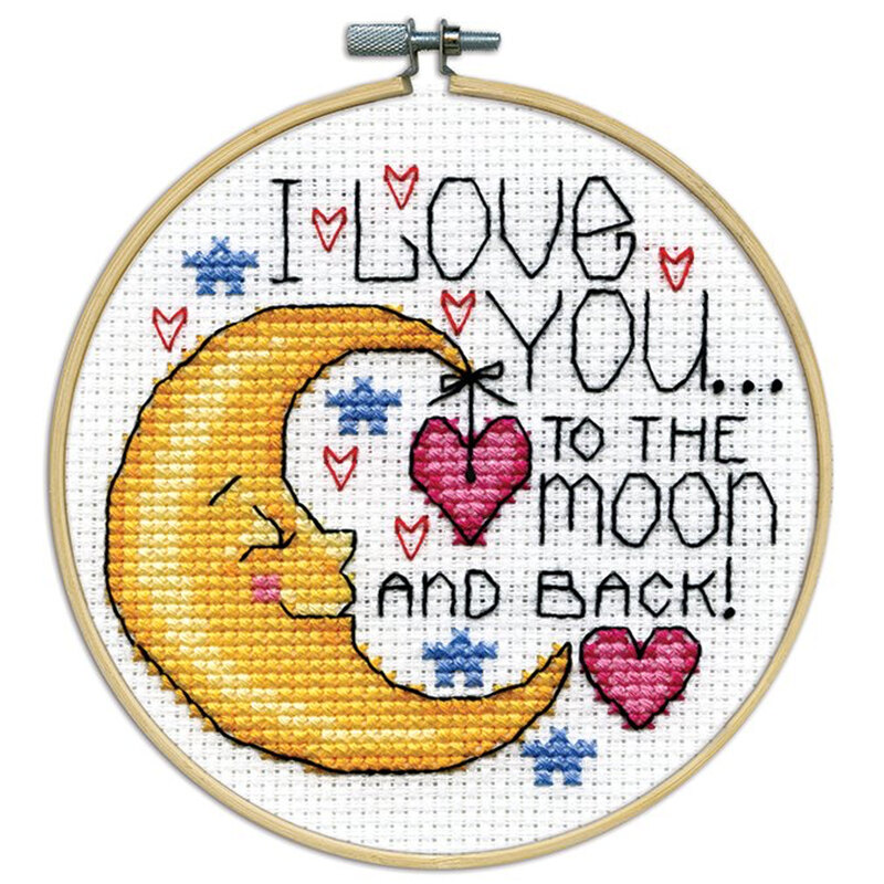 A closeup of the finished Moon cross stitch inside a wooden hoop isolated on a white background.