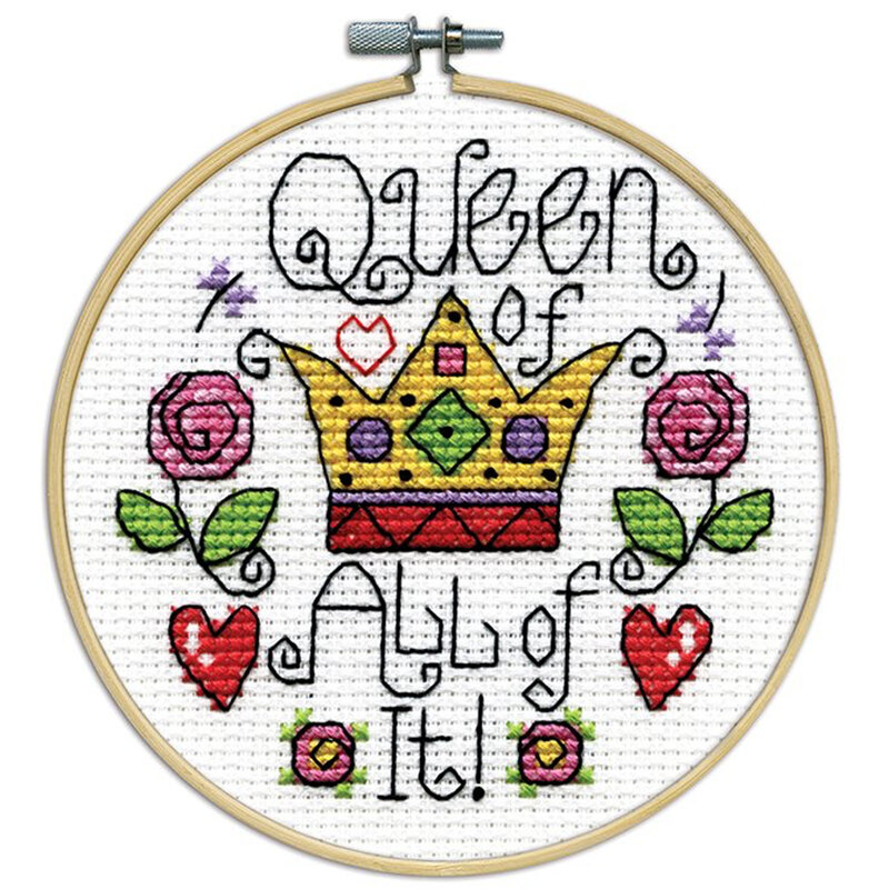 A closeup of the finished Queen cross stitch inside a wooden hoop isolated on a white background.