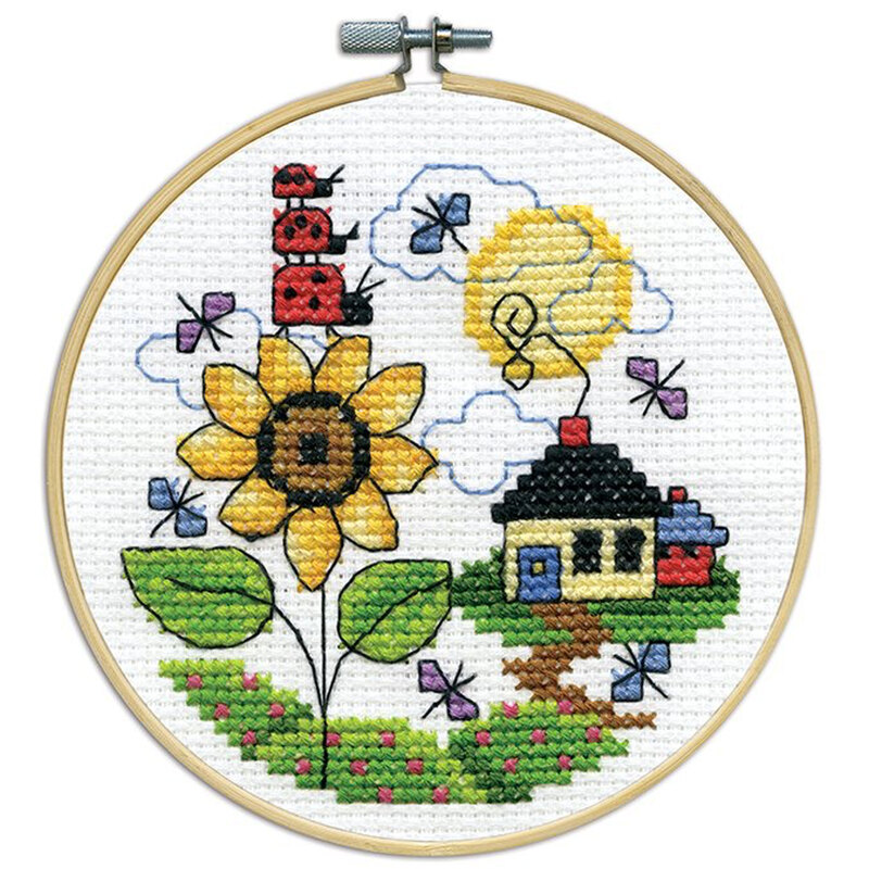 A closeup of the finished Sunflower cross stitch inside a wooden hoop isolated on a white background.