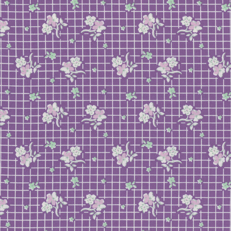 Purple fabric with white, purple and mint green flowers in rows on a white gridded background.