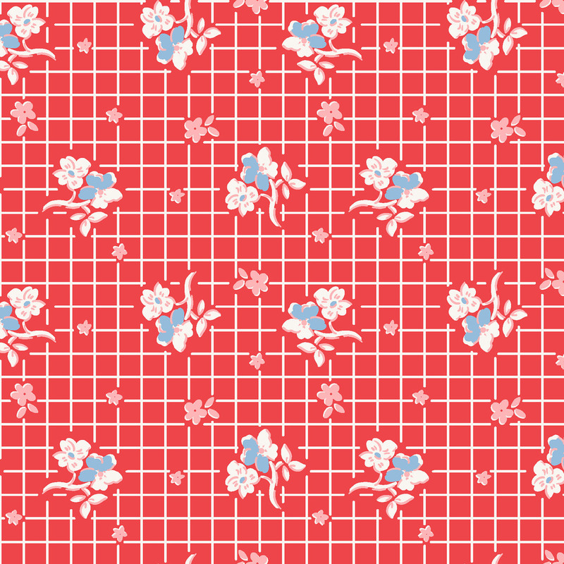 Red fabric with white, pink and blue flowers in rows on a white gridded background.