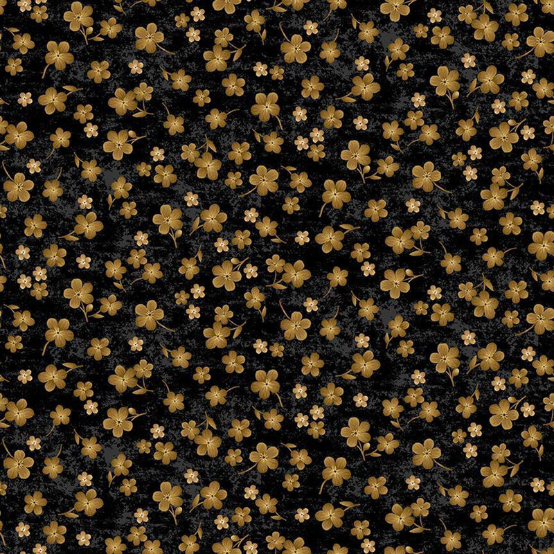 Black fabric with scattered golden flowers on a mottled background.