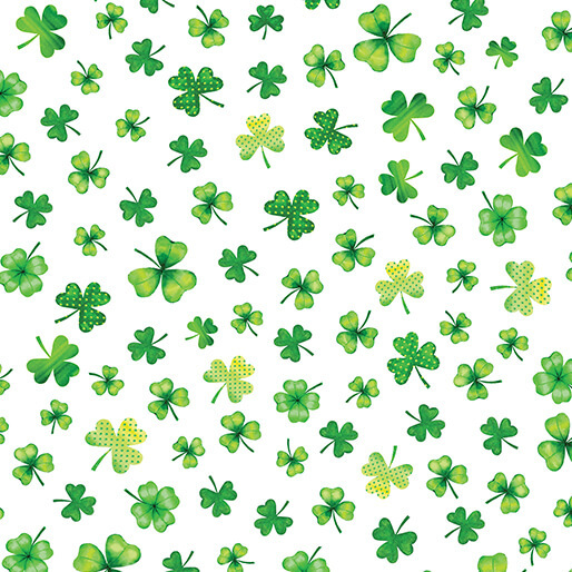 White fabric scattered with various shamrocks and four leaf clovers