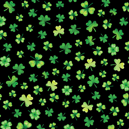 Black fabric scattered with various shamrocks and four leaf clovers