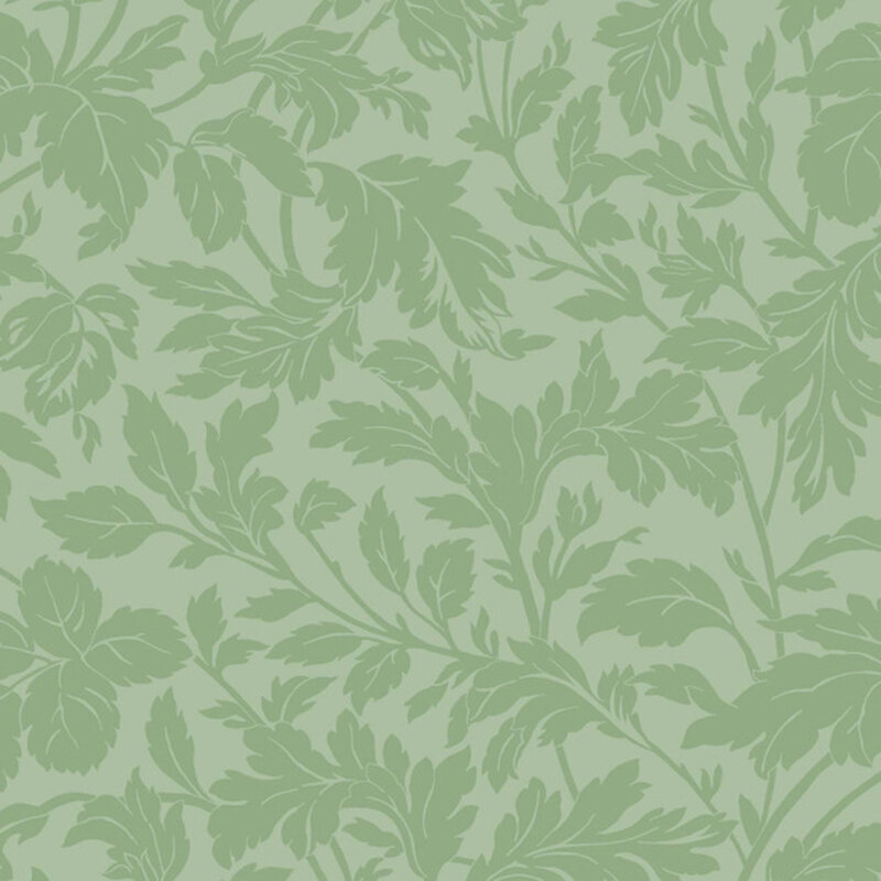 A swatch of tonal green fabric with branching leaves and stems.