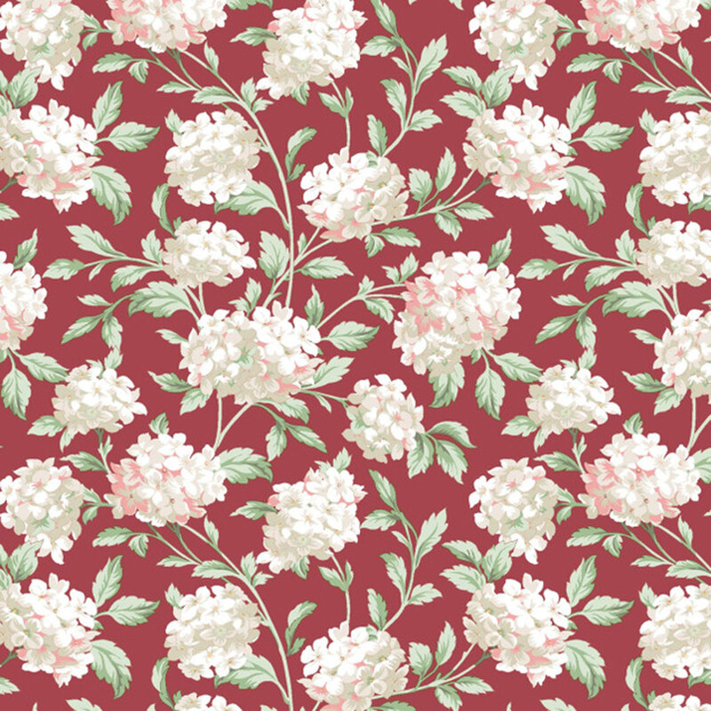 A swatch of red fabric with scattered bunches of pinkish white hydrangea flowers.