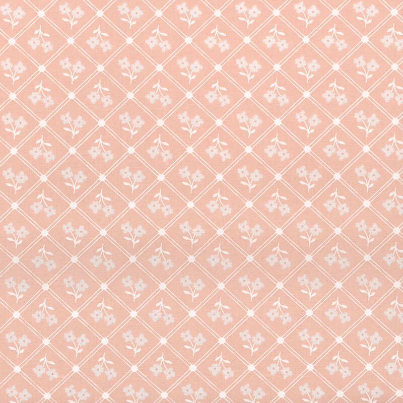 Pink fabric with a tossed flower pattern and geometric diamonds
