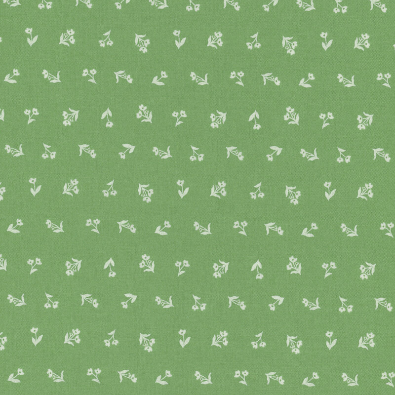 Green fabric with off white silhouettes of flowers in a ditsy pattern