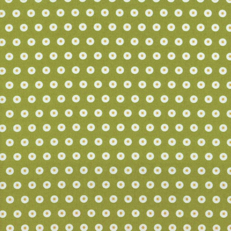 Green fabric with neat rows of white circles with asterisks in the center.
