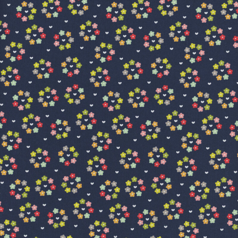 Navy fabric with small multicolored hearts surrounded by rings of multicolored flowers.