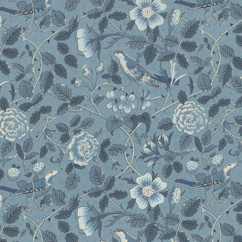 Blue fabric featuring birds amidst the sprawling vines and blooming flowers 