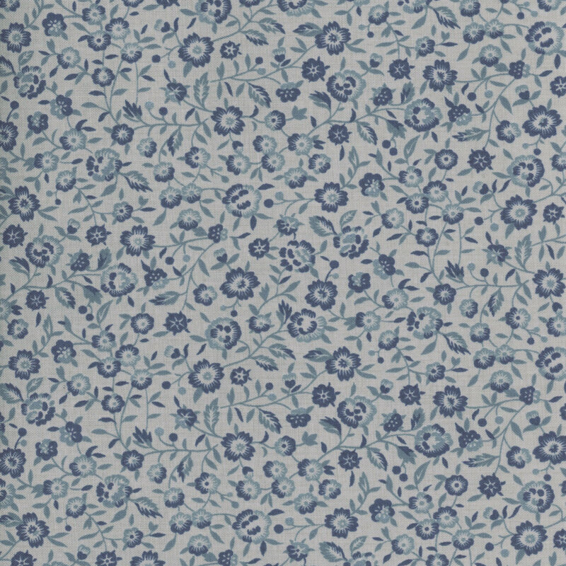 Blue tonal fabric featuring a packed design of vines and small florals