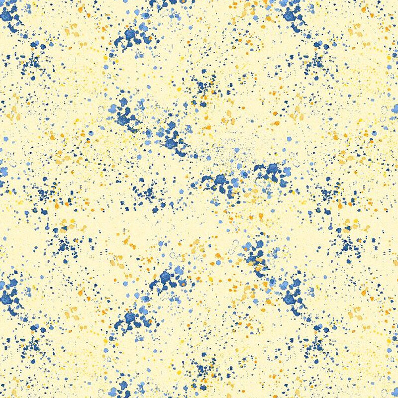 Light yellow fabric with blue and gold splatters throughout