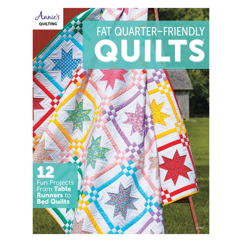 The front of the Fat Quarter-Friendly Quilts book showing one of the completed quilts included in the book displayed on a ladder in front of a barn.