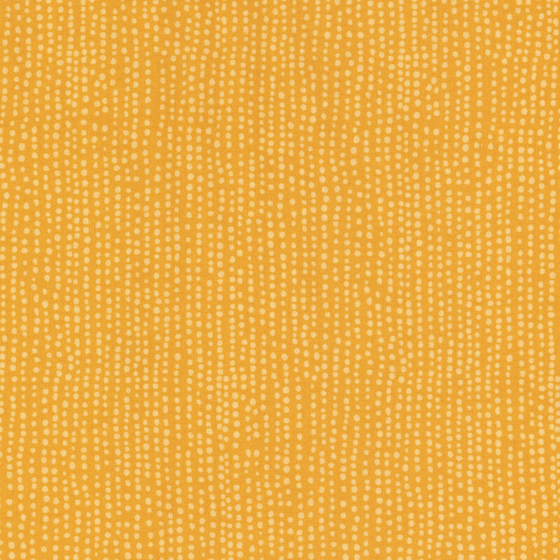 Bright yellow fabric with small tonal dots all over.