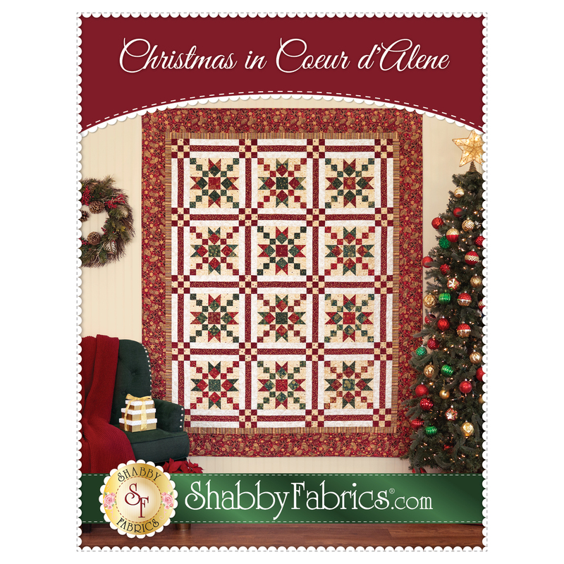 Front cover of the pattern showing the completed quilt in white, cream, red, and green fabrics from the Stof Christmas collection.