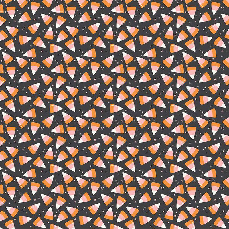 Black fabric with scattered candy corn and tiny white stars.