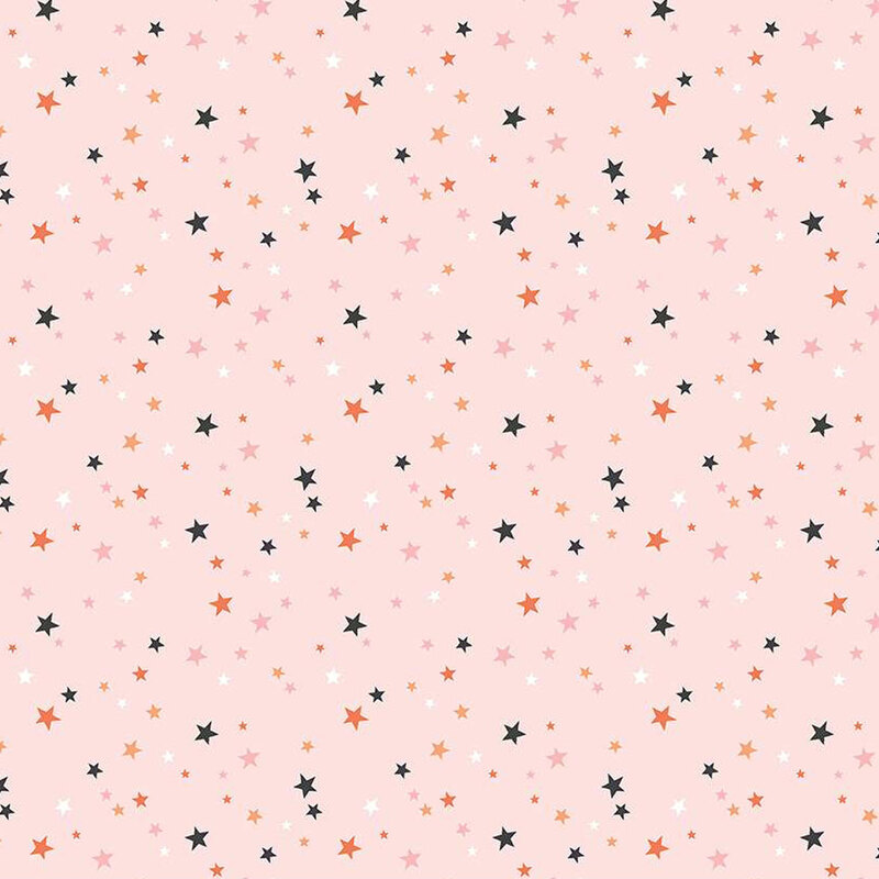 Blush pink fabric with scattered stars in Halloween colors and pink.