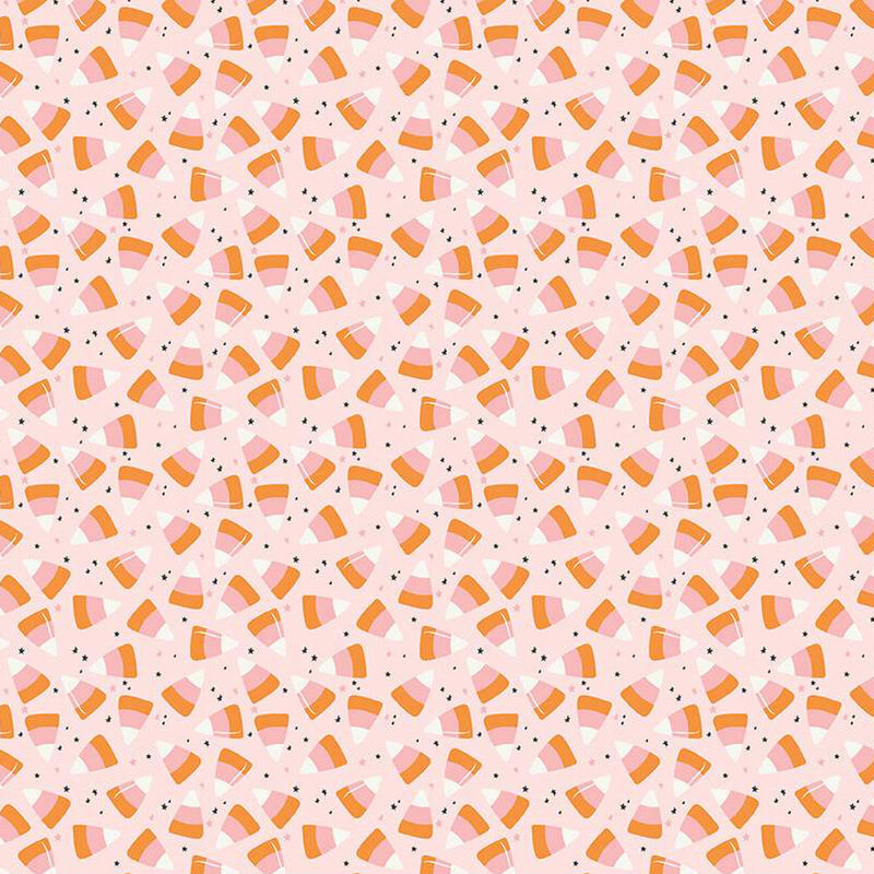 Blush pink fabric with scattered candy corn and tiny black and pink stars.