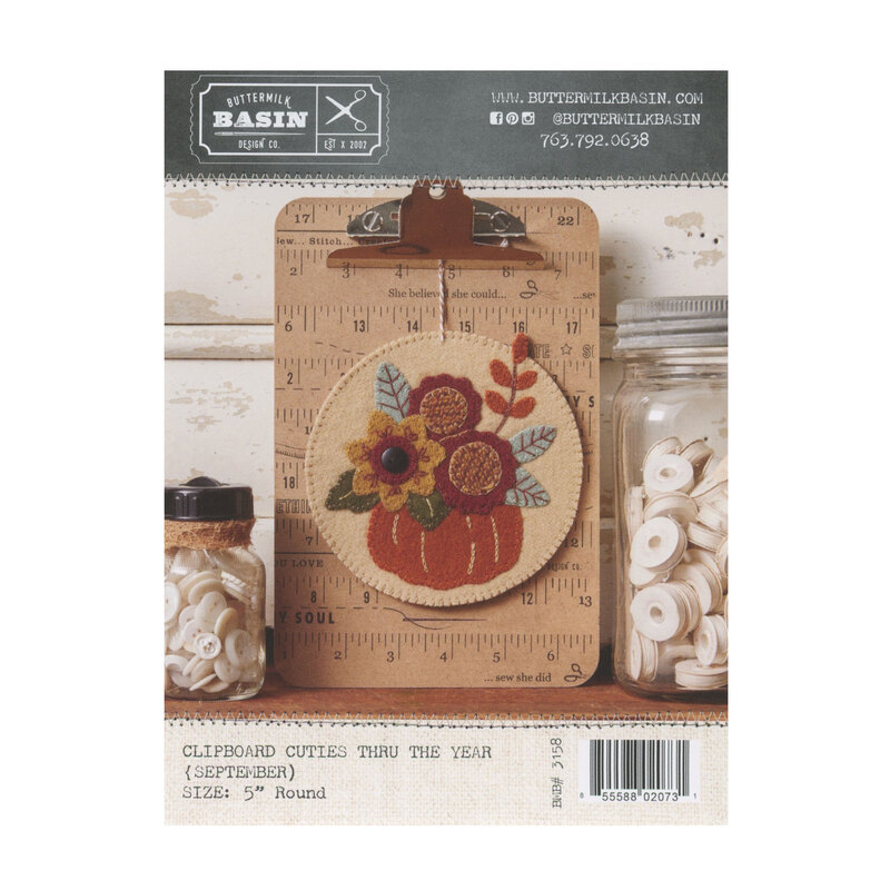 Front cover of pattern showing completed project staged on a clipboard and surrounded by coordinating decor.