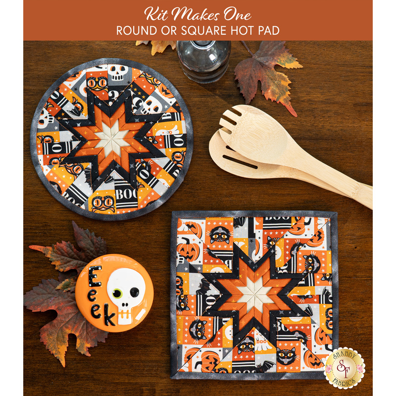 A top down shot of the completed round and square hot pads in multicolored tiles, staged on a wooden table with coordinating decor like autumn leaves and a button with a skull that says 