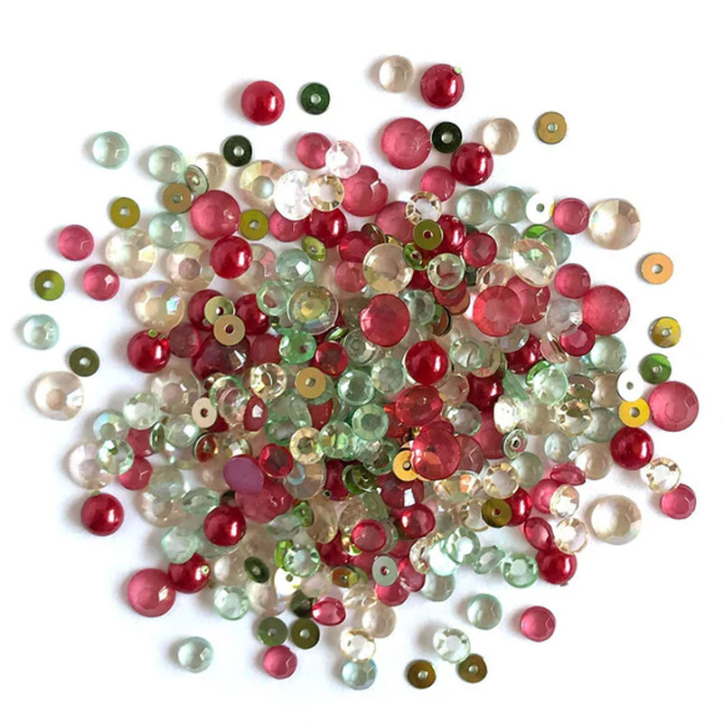 Pile of red, green, and iridescent embellishments against a white background