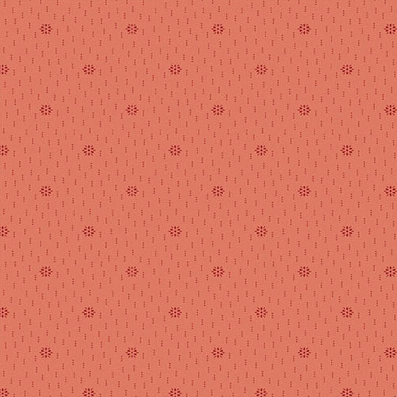 A coral fabric with a tonal starbursts of dotted clusters and dotted lines.