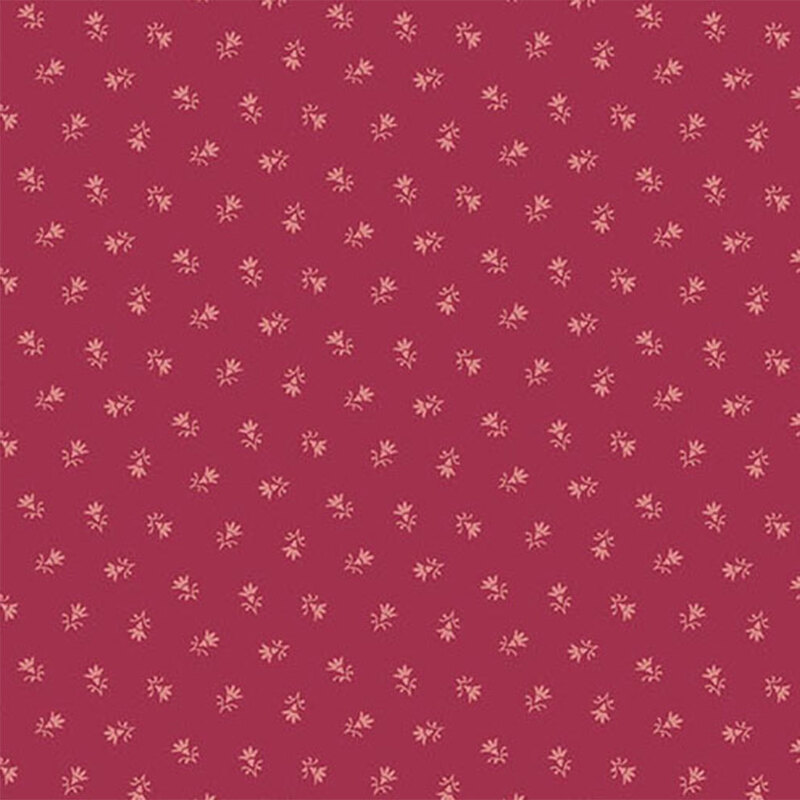 A raspberry red fabric pattern with small, delicate floral designs scattered throughout.