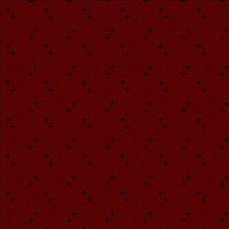 Repeating pattern of small dark dots, and floral designs on a dark red background.