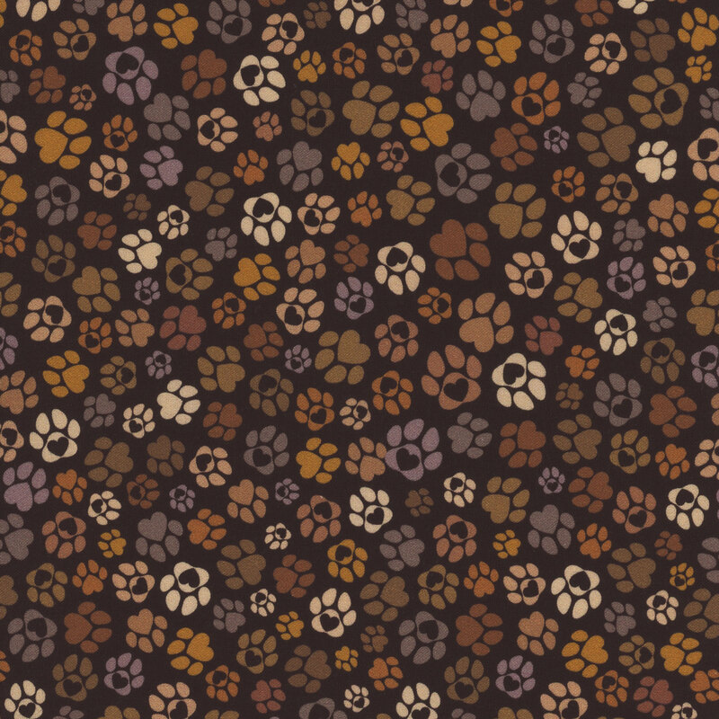 Black fabric featuring various paw print shapes in earthy tones.