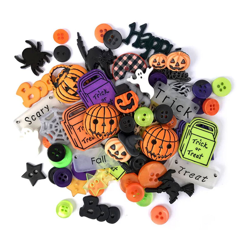 A pile of Halloween-themed buttons and embellishments, including jack o'lanterns and spider shapes.