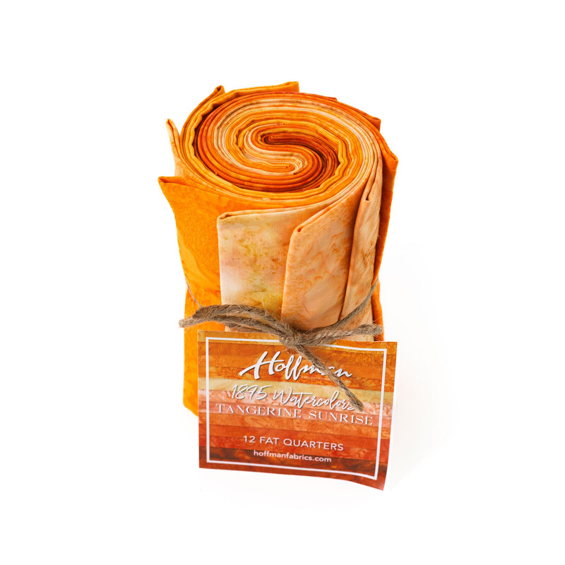 Rolled fabric bundle labeled Tangerine Sunrise, featuring 12 fat quarters in orange and peach tones.