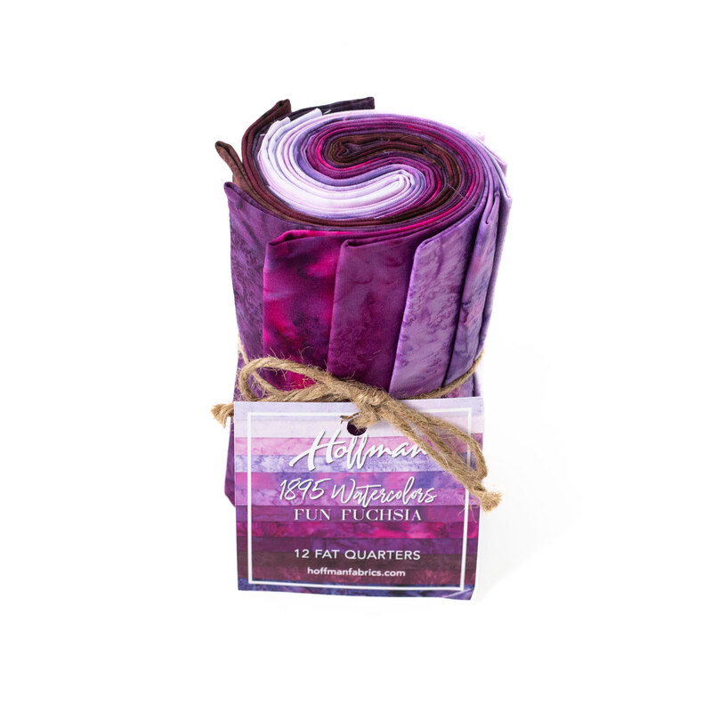 Rolled fabric bundle labeled Fun Fuchsia, featuring 12 fat quarters in purple and magenta tones.