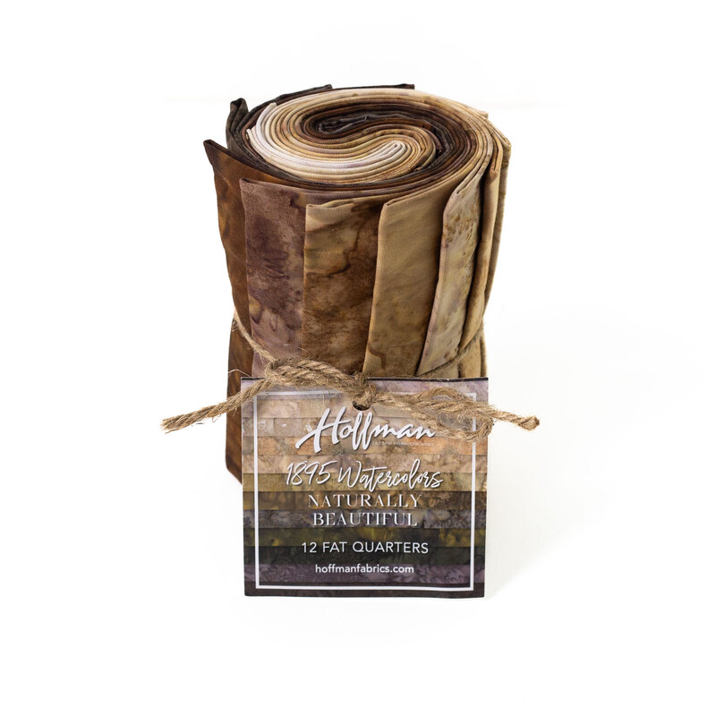 Rolled fabric bundle labeled Naturally Beautiful, featuring 12 fat quarters in brown and tan tones.