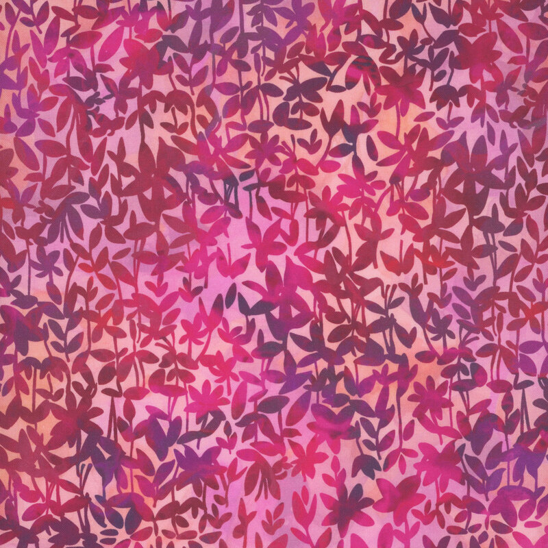 Fabric with a vibrant fuchsia background filled with overlapping leafy patterns in various shades of plum and pink.